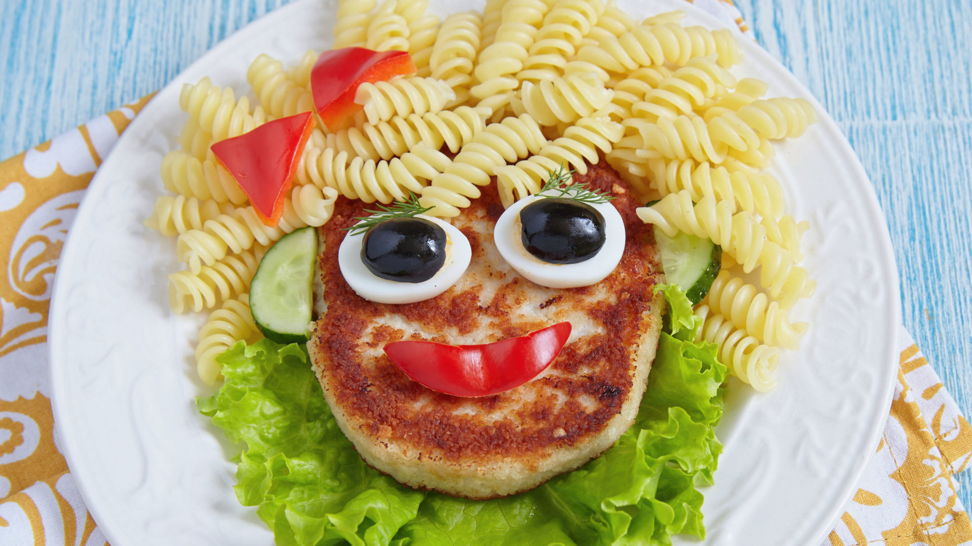 A film poster depicting a face made out of various food items. The hair is made out of fusilli, the face is a fish steak with a slice of pepper for a mouth and the two halves of a boiled egg for eyes.